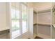 Organized walk-in closet featuring built-in shelves and ample storage at 1142 Wiley Bridge Rd, Woodstock, GA 30188