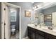 Bathroom featuring double sink vanity, framed art, and a large window for ample light at 3087 Dunton Se St, Smyrna, GA 30080