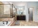 Luxurious bathroom featuring soaking tub, walk-in shower, tile floors, and double vanity at 3087 Dunton Se St, Smyrna, GA 30080