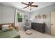 Cozy bedroom featuring a twin bed, ceiling fan, dresser and chair at 3087 Dunton Se St, Smyrna, GA 30080