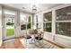 Sunlit breakfast nook with a round table, white wainscoting, and large windows at 3087 Dunton Se St, Smyrna, GA 30080