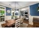 Inviting dining room with views to the living room, a rustic table, and classic blue walls at 3087 Dunton Se St, Smyrna, GA 30080