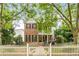 Charming two-story home featuring a brick facade, inviting front porch, and white picket fence at 3087 Dunton Se St, Smyrna, GA 30080