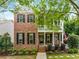 Charming two-story home featuring a brick facade, inviting front porch and manicured landscaping at 3087 Dunton Se St, Smyrna, GA 30080