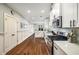 Modern kitchen with stainless steel appliances, white cabinets, and hardwood floors at 3087 Dunton Se St, Smyrna, GA 30080
