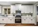 Modern kitchen with white cabinets, stainless steel appliances, and granite countertops at 3087 Dunton Se St, Smyrna, GA 30080