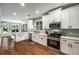 Bright kitchen with stainless steel appliances, white cabinets, and an open design at 3087 Dunton Se St, Smyrna, GA 30080
