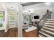 Inviting living room with a fireplace, stairs, and lots of natural light at 3087 Dunton Se St, Smyrna, GA 30080