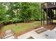 Well-maintained backyard with lush greenery, trees, and a wooden fence at 42 Treemont Se Dr, Cartersville, GA 30121