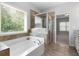 Bathroom with large tub and glass-enclosed shower at 42 Treemont Se Dr, Cartersville, GA 30121