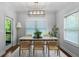 Elegant dining room with modern lighting, and large windows allowing for plenty of natural light at 42 Treemont Se Dr, Cartersville, GA 30121