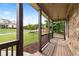 Spacious covered front porch with wooden railings and a view of the beautifully landscaped front yard at 42 Treemont Se Dr, Cartersville, GA 30121