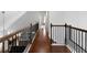 Second floor hallway with hardwood flooring and wrought iron railing at 42 Treemont Se Dr, Cartersville, GA 30121