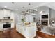 Spacious kitchen with an island overlooking a cozy living room with a fireplace at 42 Treemont Se Dr, Cartersville, GA 30121