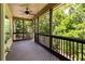 Relaxing screened porch with wood flooring and views of the surrounding trees at 42 Treemont Se Dr, Cartersville, GA 30121