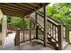Exterior wooden staircase with beautiful views of green foliage at 42 Treemont Se Dr, Cartersville, GA 30121