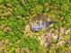 Birds-eye view of a secluded home, accessible via a private driveway amidst a dense forest at 555 E Valley Ne Rd, Rydal, GA 30171