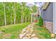 A stepping stone path leads to a charming home with a covered porch surrounded by trees at 555 E Valley Ne Rd, Rydal, GA 30171