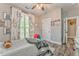 Stylish bedroom with unique decor, ceiling fan and hardwood floors at 555 E Valley Ne Rd, Rydal, GA 30171