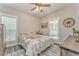 Charming bedroom with rustic decor, ceiling fan and natural light at 555 E Valley Ne Rd, Rydal, GA 30171