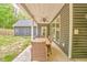 Covered patio with dining table set and open backyard at 555 E Valley Ne Rd, Rydal, GA 30171