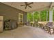 Covered patio with outdoor seating, a grill, and ceiling fan at 555 E Valley Ne Rd, Rydal, GA 30171