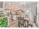 View of dining room, kitchen and living room. Dining room table has chairs and a bench at 555 E Valley Ne Rd, Rydal, GA 30171