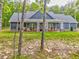 Inviting home exterior with a cozy front porch, complete with rocking chairs and lush landscaping at 555 E Valley Ne Rd, Rydal, GA 30171