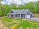 Charming home featuring a welcoming front porch, well-manicured lawn, and attached garage at 555 E Valley Ne Rd, Rydal, GA 30171