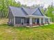 Picturesque home showcasing a classic front porch with rocking chairs, perfect for relaxation at 555 E Valley Ne Rd, Rydal, GA 30171