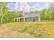 A picturesque home with a covered porch surrounded by lush greenery on a large lot at 555 E Valley Ne Rd, Rydal, GA 30171