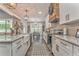 Well-appointed kitchen featuring granite countertops, white cabinetry, and modern appliances, creating a culinary dream at 555 E Valley Ne Rd, Rydal, GA 30171