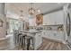 Beautiful kitchen features a large island with seating, granite countertops, and stylish light fixtures at 555 E Valley Ne Rd, Rydal, GA 30171
