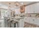 Modern kitchen with granite countertops, white cabinets, a large island, and stylish lighting fixtures, creating a functional space at 555 E Valley Ne Rd, Rydal, GA 30171