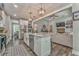 Open kitchen and living room layout features modern appliances and a large island with stainless steel dishwasher at 555 E Valley Ne Rd, Rydal, GA 30171