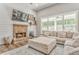 Bright living room featuring a fireplace, large windows, and a comfortable sectional sofa, ideal for Gathering gatherings at 555 E Valley Ne Rd, Rydal, GA 30171