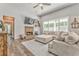 Cozy living room with a fireplace, open windows with wooded view, and stylish decor creating a warm atmosphere at 555 E Valley Ne Rd, Rydal, GA 30171