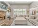 Inviting living room with a brick fireplace, bright windows, and a large sectional sofa, perfect for relaxing and entertaining at 555 E Valley Ne Rd, Rydal, GA 30171