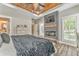 Luxurious bedroom featuring a modern fireplace, hardwood floors, and ample natural lighting at 555 E Valley Ne Rd, Rydal, GA 30171