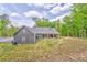 Rear view of house with a large covered patio for outdoor enjoyment and relaxation at 555 E Valley Ne Rd, Rydal, GA 30171