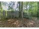 Backyard view with wood fence and mature trees at 5723 Fieldstone Dr, Lithonia, GA 30038