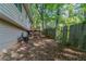 Fenced in backyard, including a small stairway to a deck and part of the home's siding at 5723 Fieldstone Dr, Lithonia, GA 30038