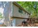 View of backyard with stairs leading to wooden deck and home's exterior siding at 5723 Fieldstone Dr, Lithonia, GA 30038
