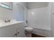 This bathroom includes a white vanity, toilet, and a tub and shower combo with white tile surround at 5723 Fieldstone Dr, Lithonia, GA 30038