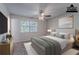 This bedroom features a ceiling fan, a plush bed, and a large window with natural light at 5723 Fieldstone Dr, Lithonia, GA 30038