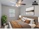 Staged bedroom with bed, neutral decor, and ample natural light at 5723 Fieldstone Dr, Lithonia, GA 30038