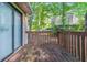 Wooden deck off the home with sliding glass door and trees at 5723 Fieldstone Dr, Lithonia, GA 30038