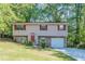 Charming two-story home with red shutters, stone accents, front yard, and driveway at 5723 Fieldstone Dr, Lithonia, GA 30038