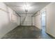 This empty garage provides ample storage space, with an automatic door and attached entryway at 5723 Fieldstone Dr, Lithonia, GA 30038