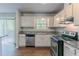 Well-lit kitchen featuring granite countertops, stainless appliances, and bright cabinetry at 5723 Fieldstone Dr, Lithonia, GA 30038